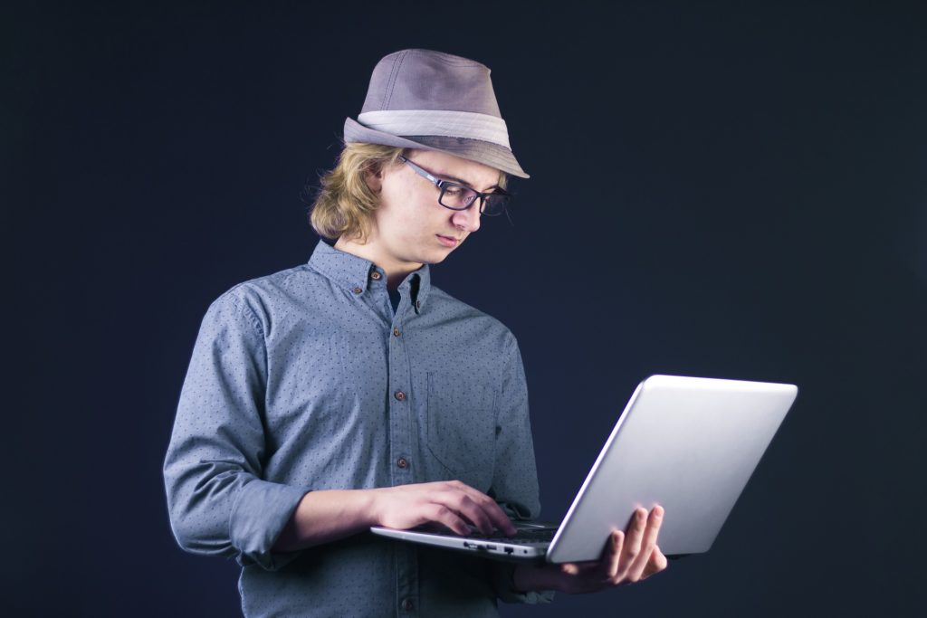 Geek holding laptop