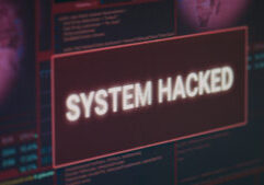 Computer monitor showing hacked system alert message flashing on screen, dealing with hacking and cyber crime attack. Display with security breach warning and malware threat. Close up.
